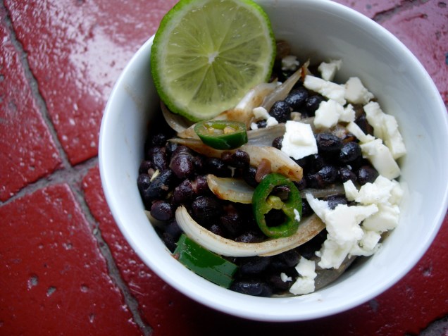 black beans with sautéed garlic and onions, chili, lime, a touch of cinnamon and brown sugar, good extra-virgin olive oil, and queso fresco